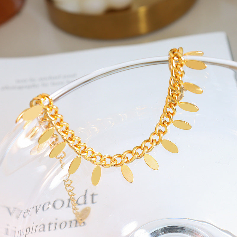 Thai Elegance: Leaf Tassel Bracelet in Titanium Steel with 18k Gold Plating.